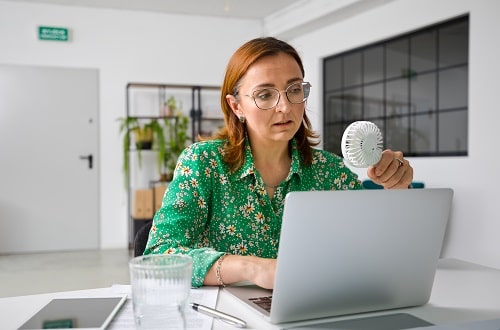 Menopausal Woman With Fan iStock izusek